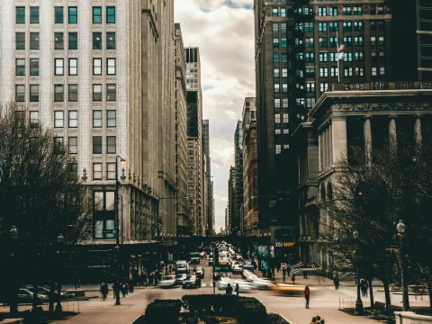 A sunlit Chicago street framed by tall city buildings